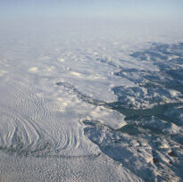 An overhead image of an icy coastline