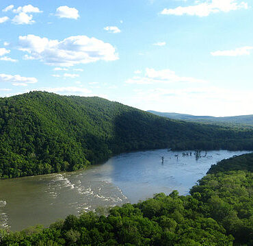 The Potomac River winds through dense green forests